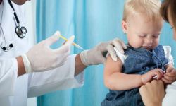 Pediatrician makes vaccination to small girl