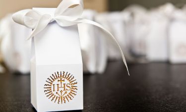 A first holy communion paper bags containing thank you notes for guests invited to the ceremony. IHS inscription, catholic religion abstract.