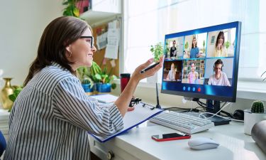 Female teacher working at home remotely, online lesson with group teenage students, teaching looking at computer screen sitting at home. Distance virtual class course interactive lesson video conference